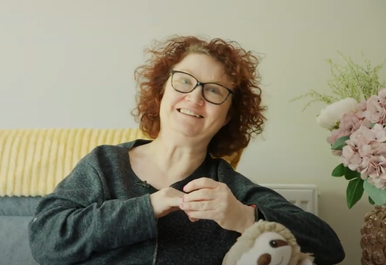 Image of a woman sitting on a couch.