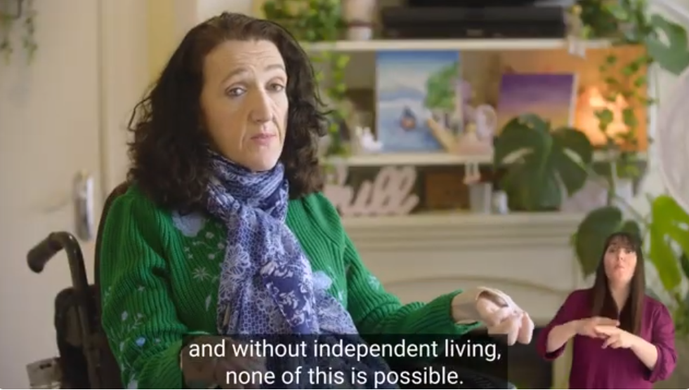 Still from a video showing a woman in a wheelchair talking about supports.